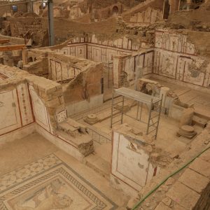 Excavated Roman house ruins with frescoes and mosaics in Ephesus archaeological site.