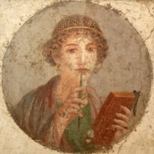 Ancient Roman fresco of a young man reading a scroll with a stylus.