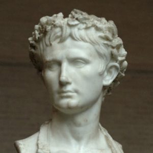Classical marble bust of a young Roman man with curly hair.
